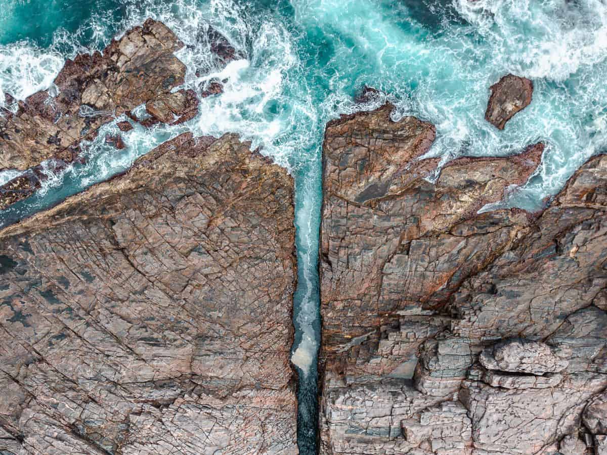 Theakstone Crevasse at Whalers Way drone top down photo showing crevasse and ocean.