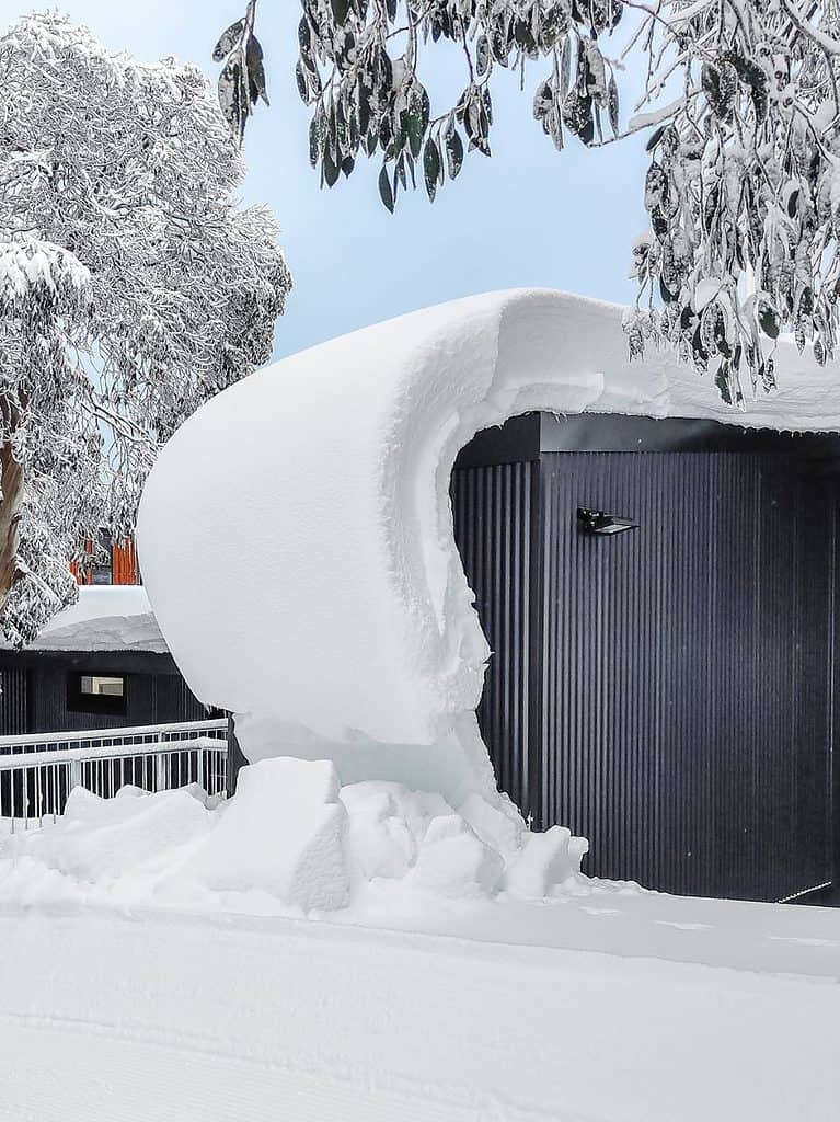 Build up off snow curling off roof at Falls Creek. 